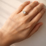 Hand wearing a lab diamond ring on a light background at LeGassick.