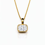 Gold necklace with a lab grown diamond pendant on a white background