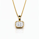 Gold necklace with a lab grown diamond pendant on a white background