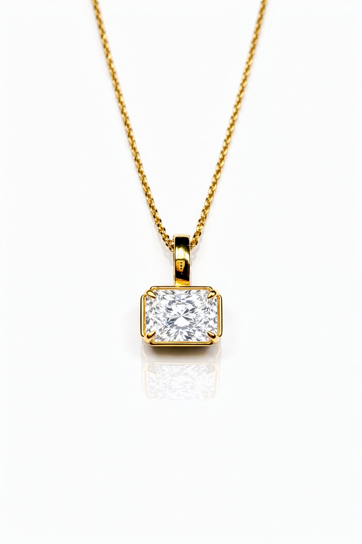 Gold necklace with a lab grown diamond pendant on a white background