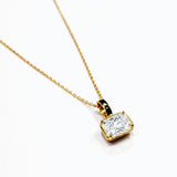 Gold necklace with a lab grown diamond pendant on a white background