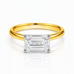 Gold ring with a rectangular lab grown diamond on a white background