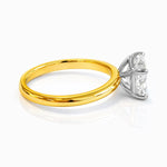 Gold ring with a rectangular lab grown diamond on a white background