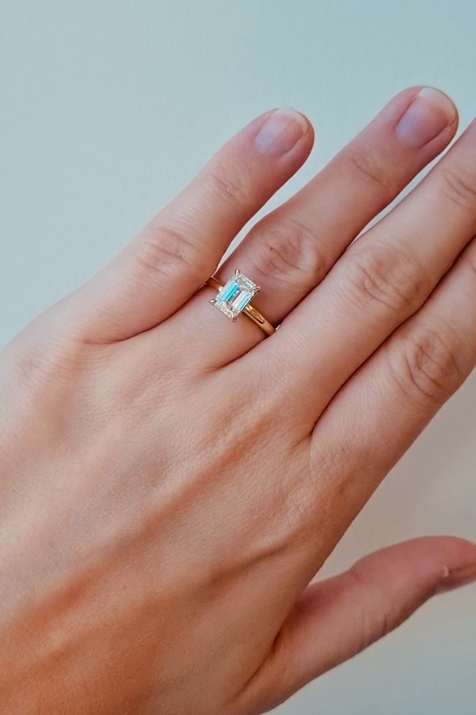 Gold ring with a large lab grown emerald cut diamond on a lady's hand at LeGassick, Gold Coast, Australia.