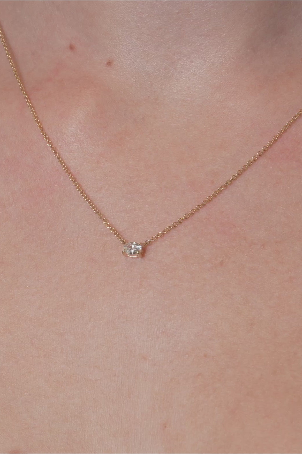 Gold necklace with a lab grown diamond pendant on a person's neck, at LeGassick, Gold Coast, Australia.