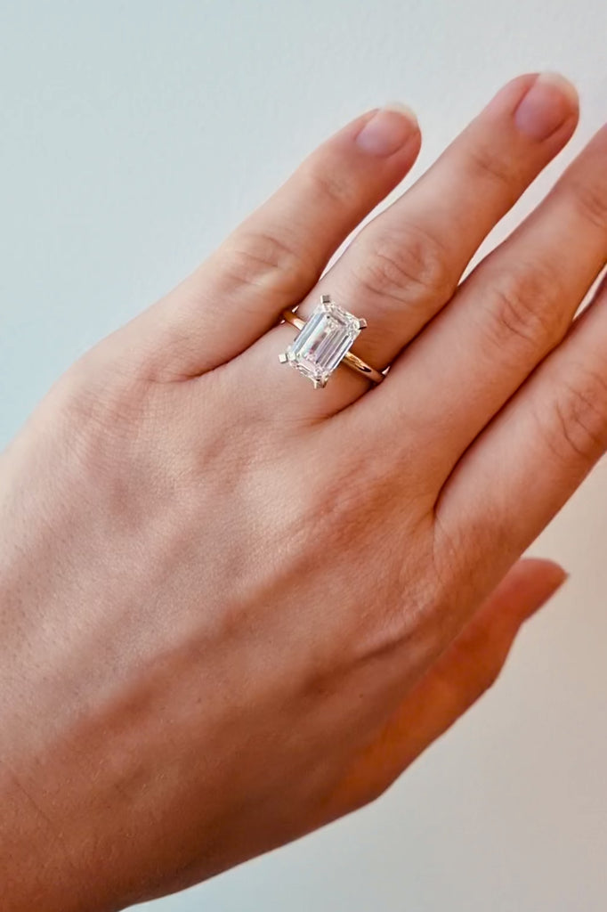 Gold ring with a large lab grown emerald cut diamond on a lady's hand at LeGassick, Gold Coast, Australia.