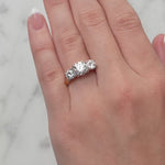 Gold ring with three diamond stones on a white background at LeGassick