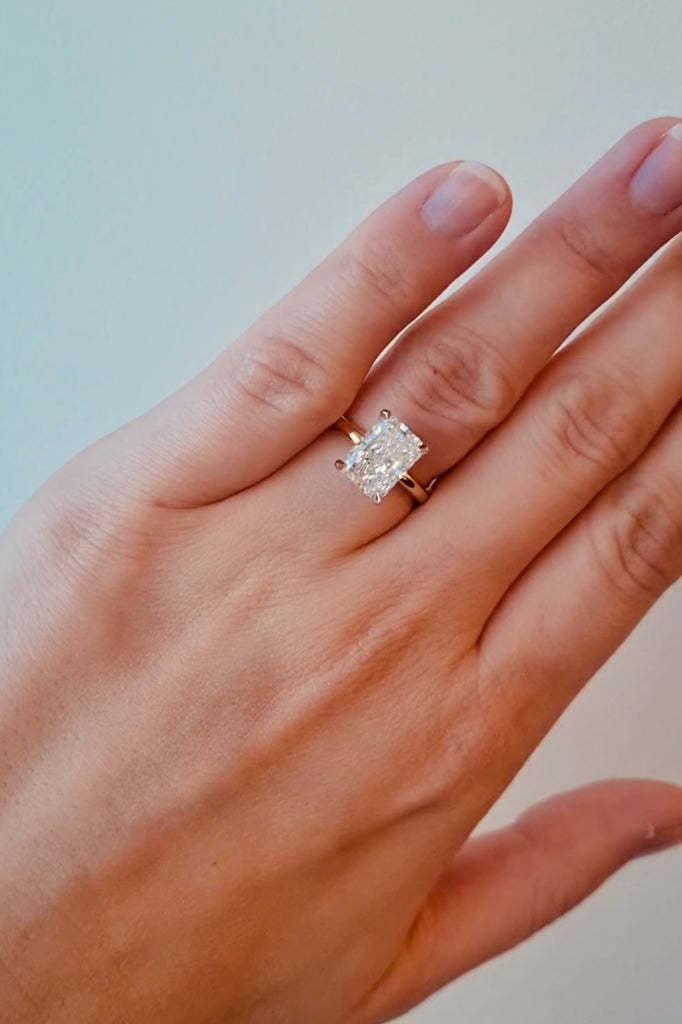 Gold ring with a lab diamond on a hand against a neutral background at LeGassick.