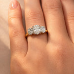 Close-up of a hand wearing a lab diamond ring on a neutral background