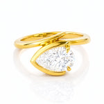 Gold ring with a pear-shaped lab grown diamond on a white background