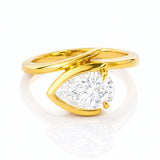 Gold ring with a pear-shaped lab grown diamond on a white background