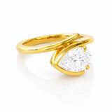 Gold ring with a pear-shaped lab grown diamond on a white background