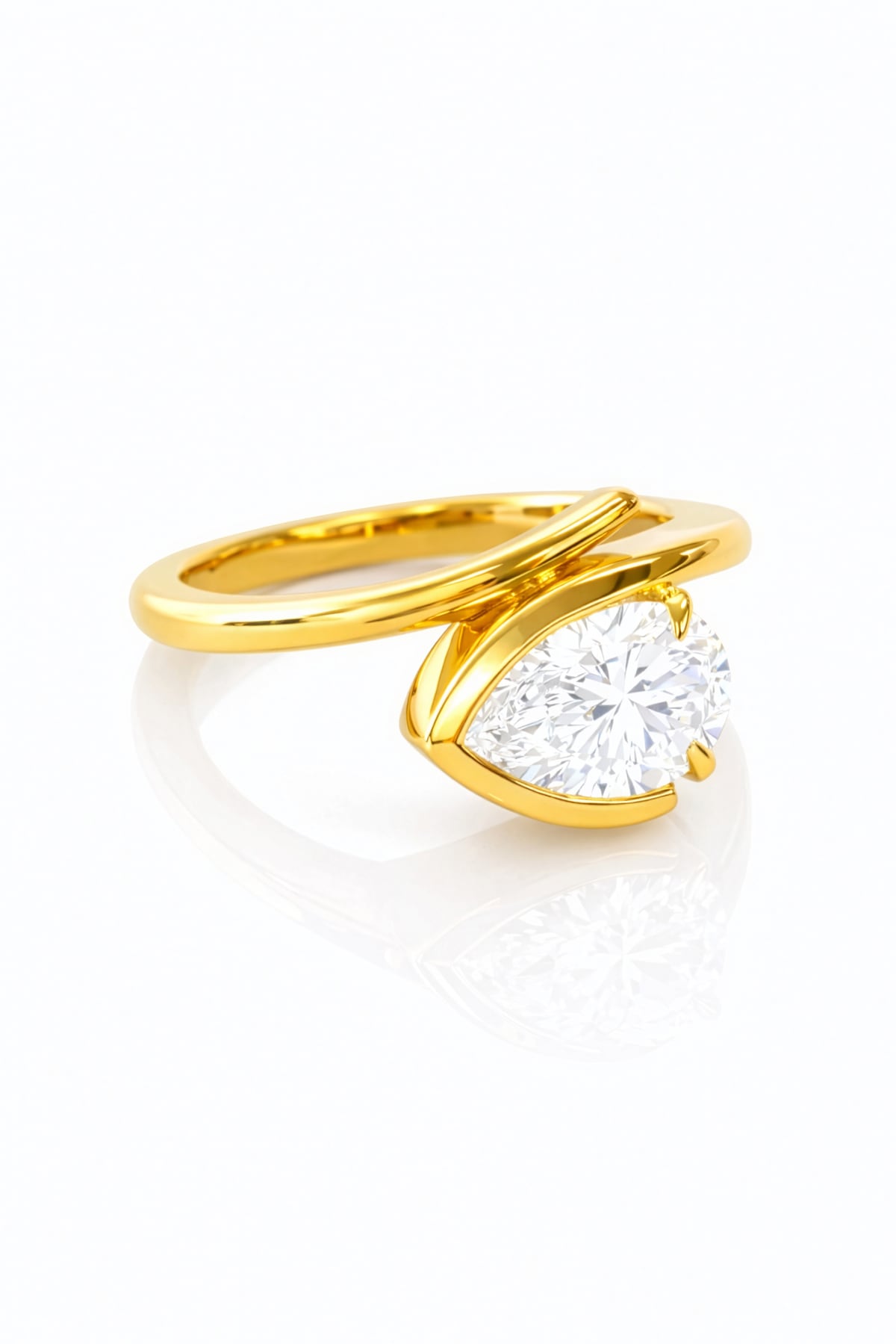 Gold ring with a pear-shaped lab grown diamond on a white background